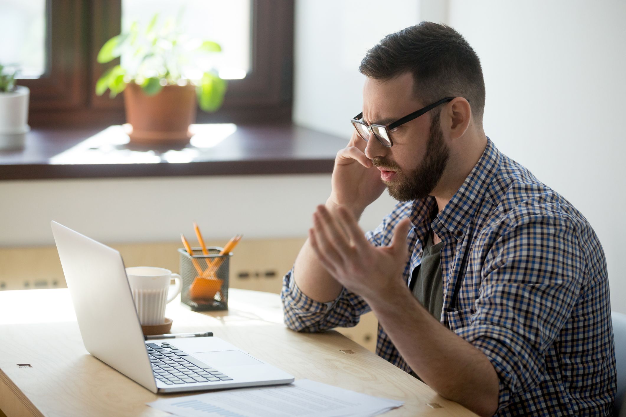 Frustrated man unable to control anger over the phone