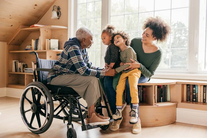 A family connecting with their grandmother in a wheelchair.