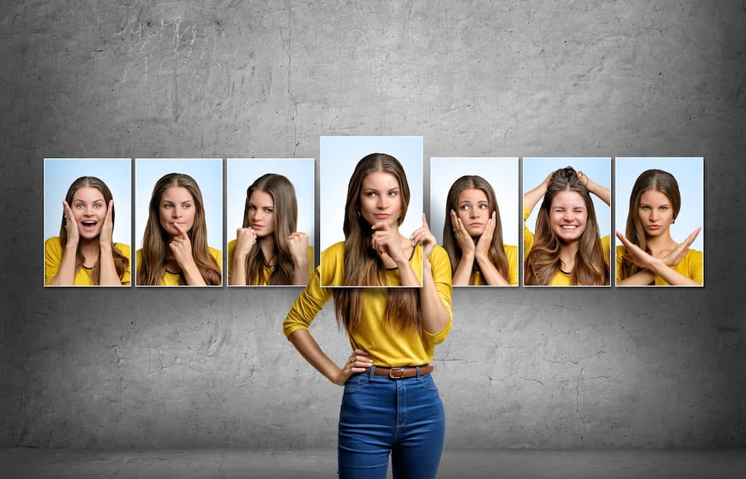 Girl-holds-and-changes-her-face-portraits-with-different-emotions-518951630_SMALL_Compressed