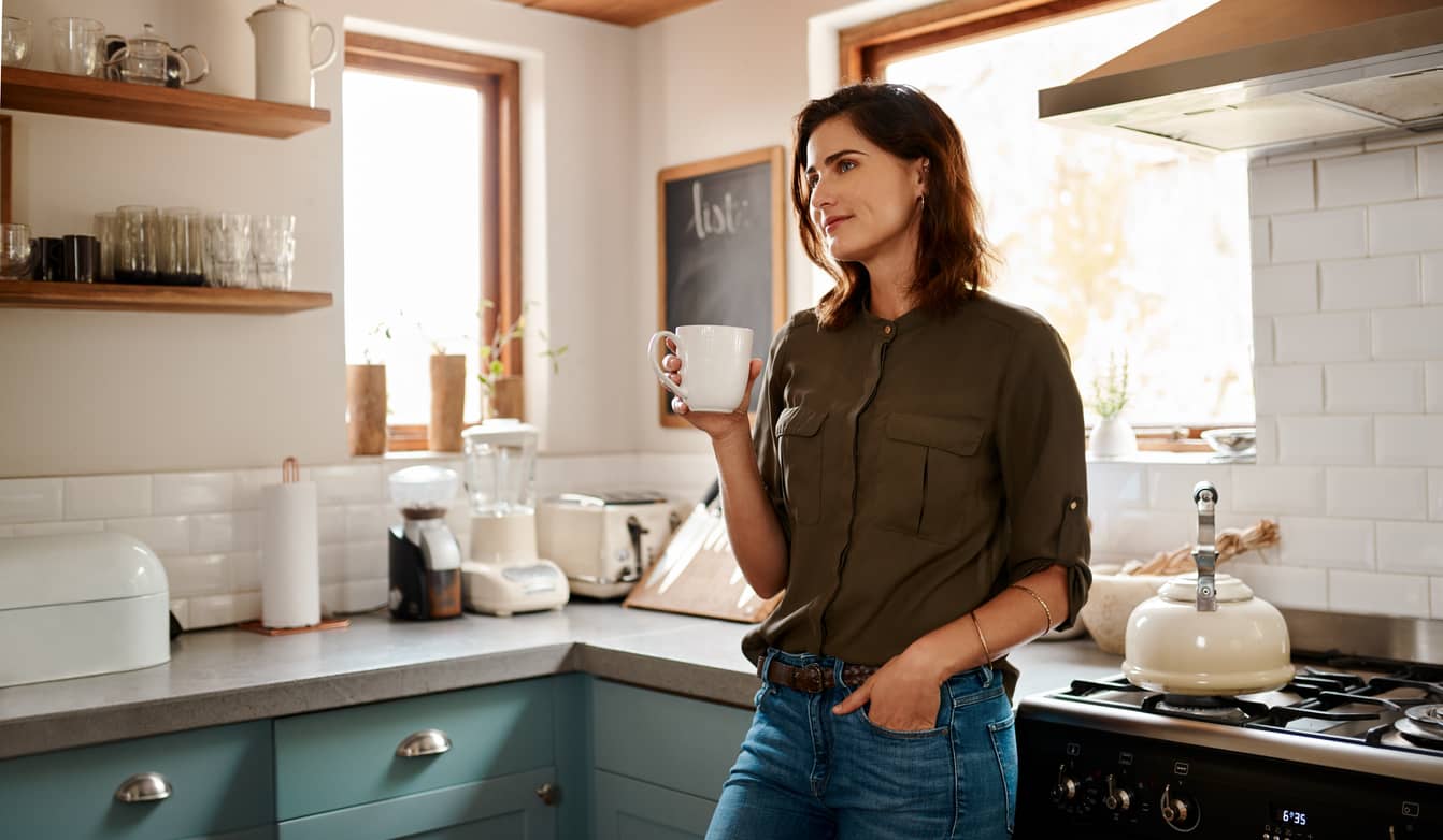 Young woman sipping on a cup of herbal tea for self-care.