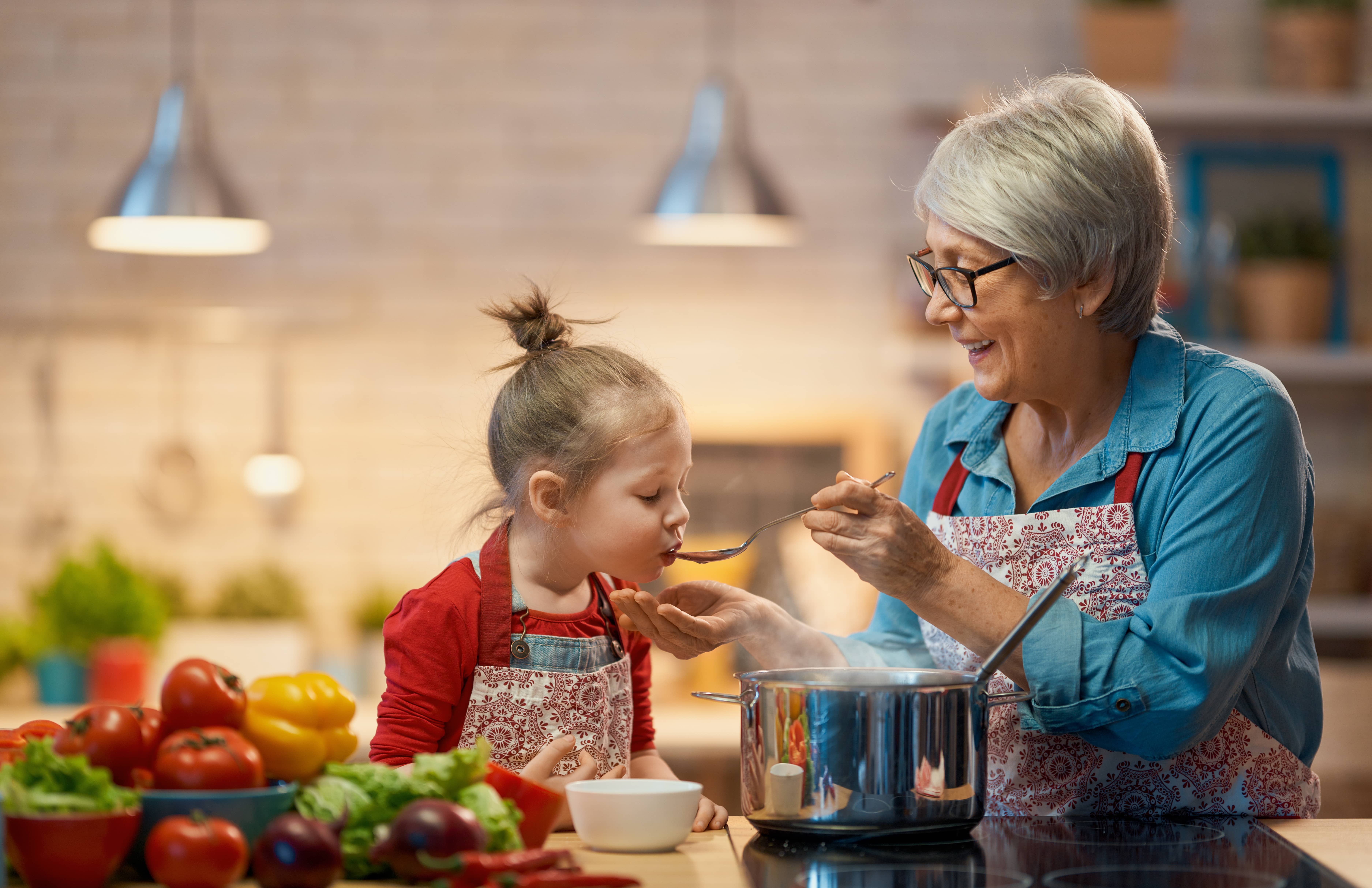 Grandma and granddaughter cooking in the kitchen