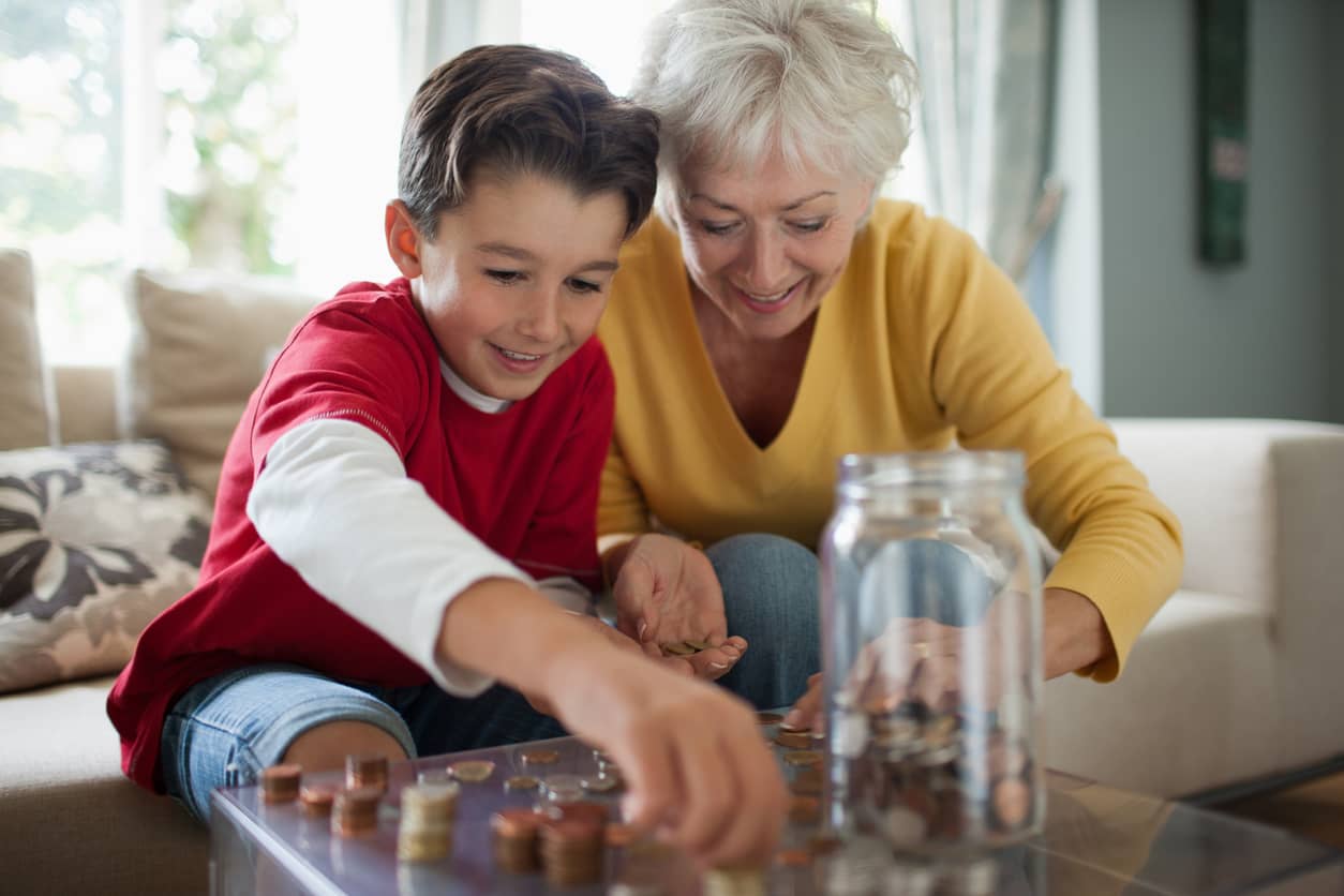 Grandmother and grandson counting coins together.