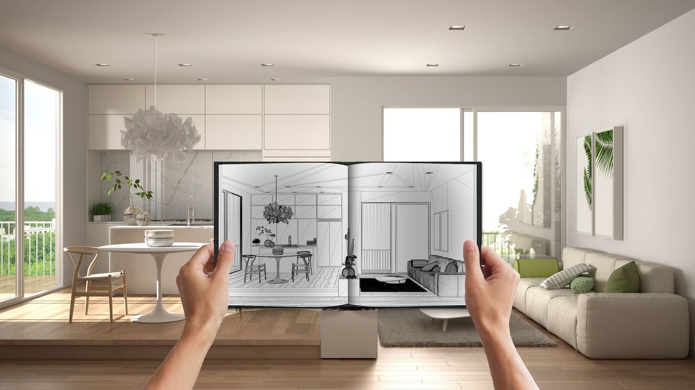 Hands holding notepad with a creative kitchen design imagining future self.