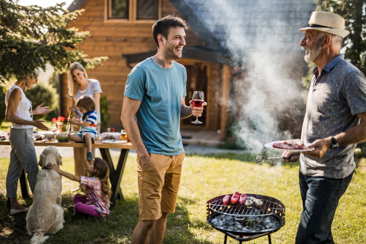 Blended family having a barbecue in their backyard.