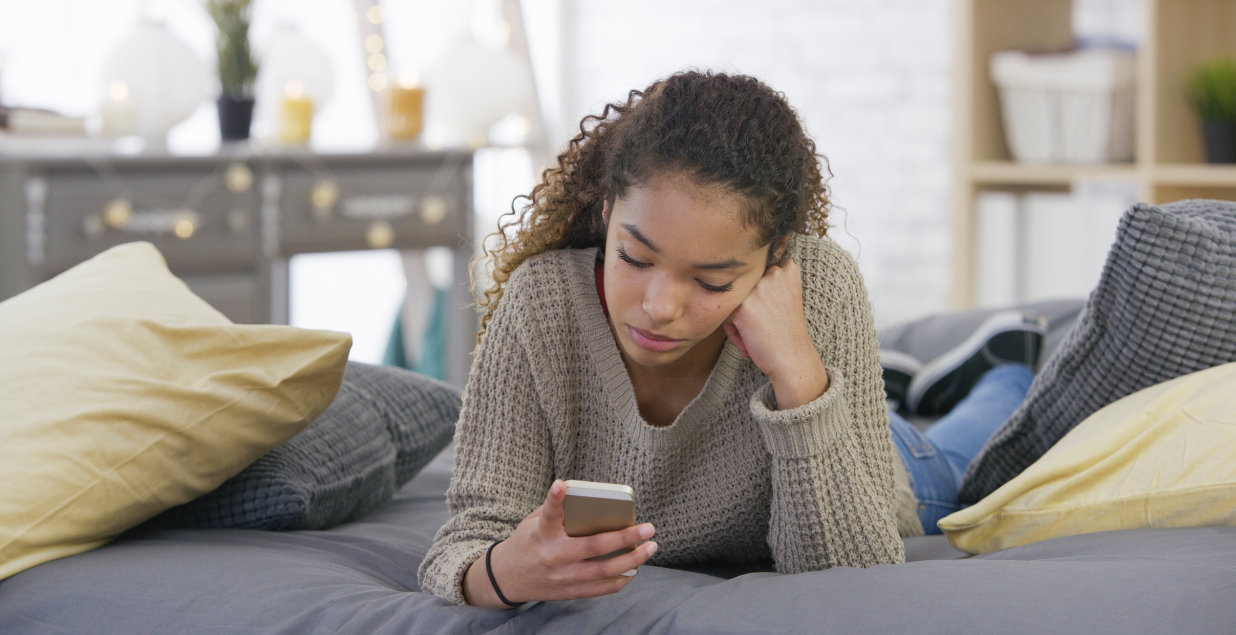 Young upset girl on her phone who needs emotional intelligence.