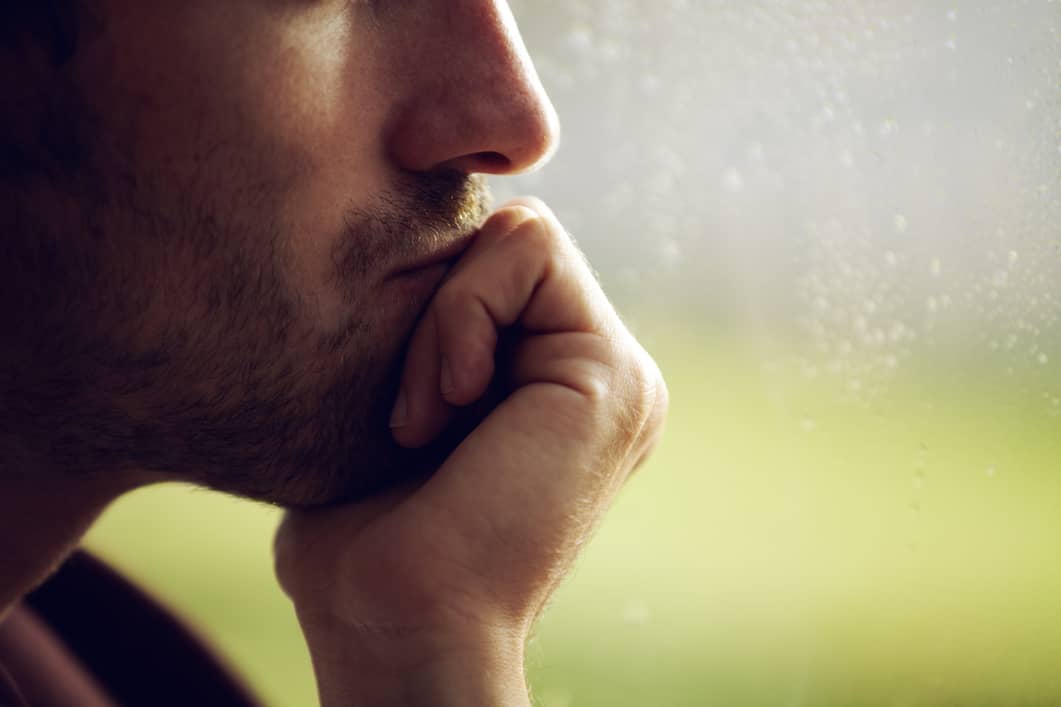 A man deep in thought seeking an emotional reset.