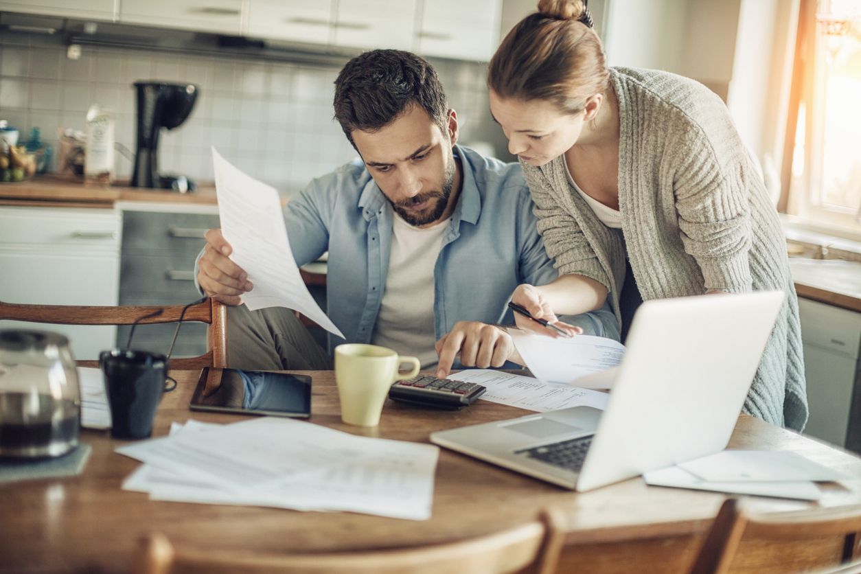 A couple figuring out a budget to save money