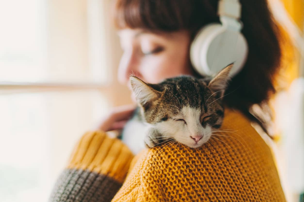 Woman self-soothing by cuddling with her cat