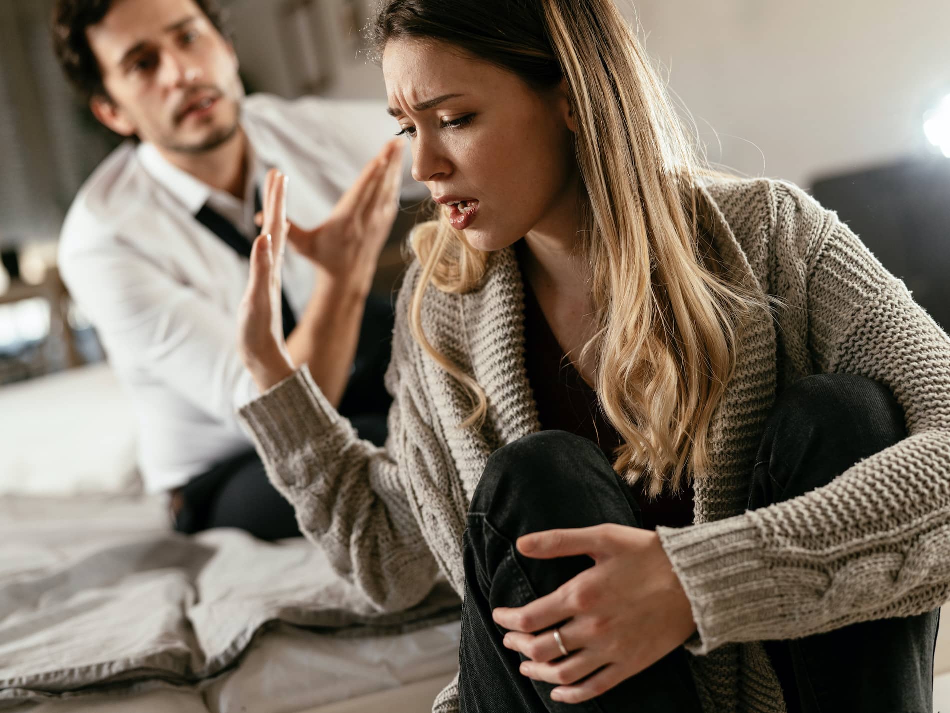 Husband and wife are arguing at home; a angry man lacking self-awareness is yelling at his wife.