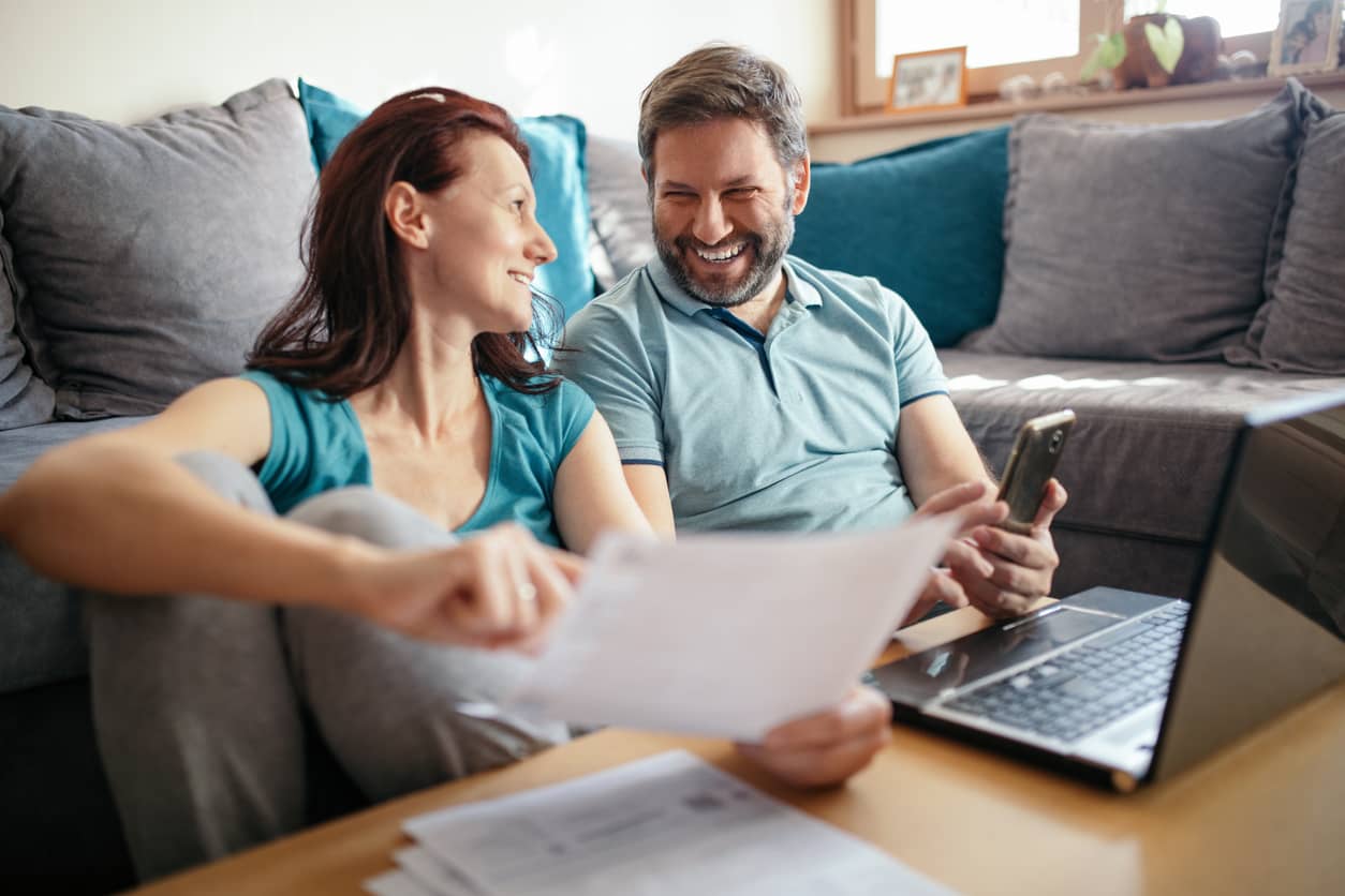 Husband and wife talking about money at a computer.