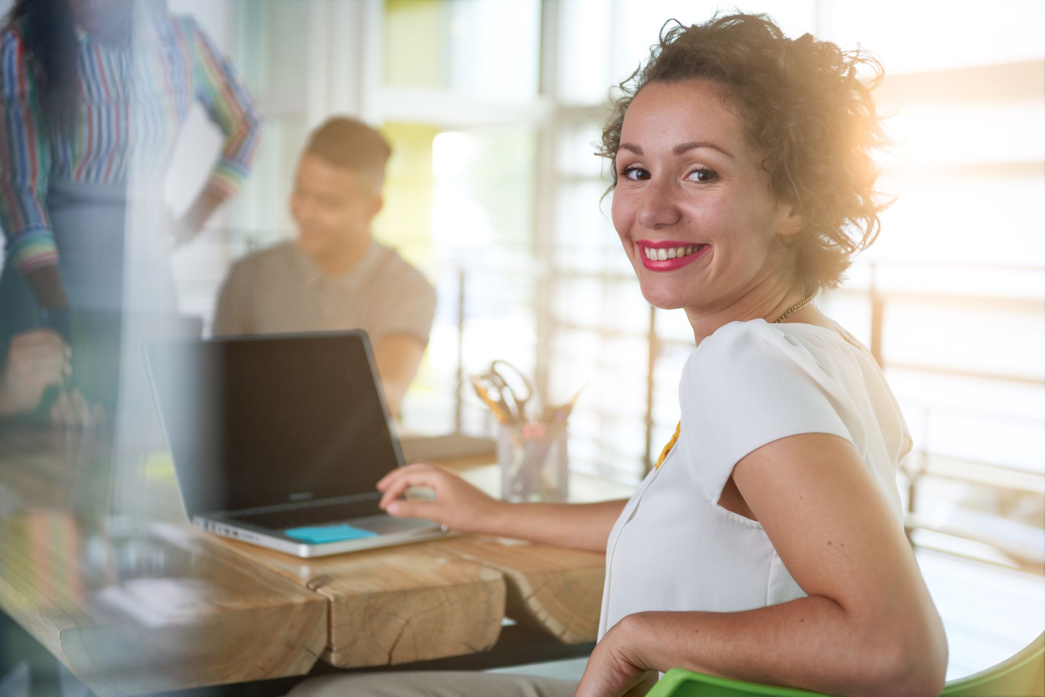 Happy and engaged employee working on her computer