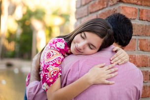 Young girl hugging her father with gratitude