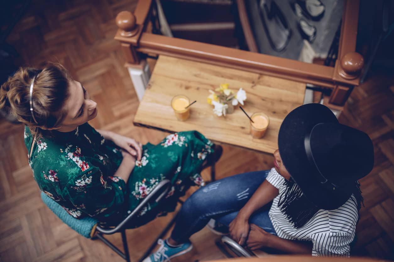 Two women communicating at a coffee shop