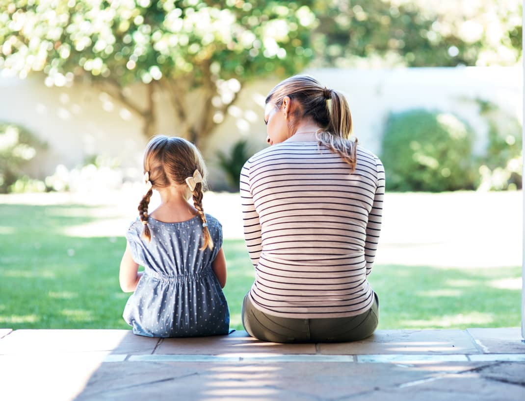 Mom empathizing with her daughter on the porch