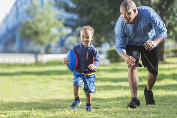 A father chasing his son and exercising his gross motor