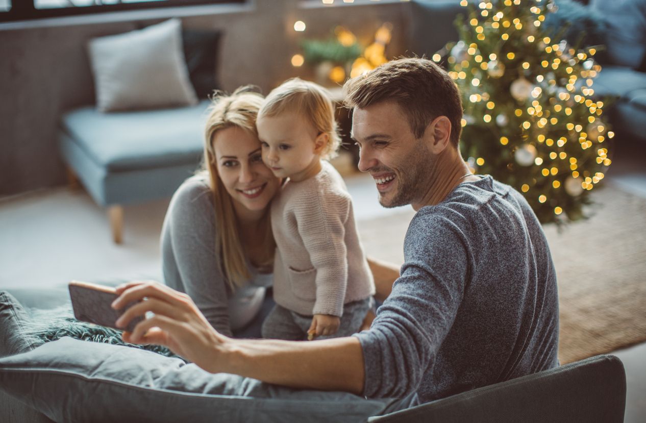 Family taking a selfie by Christmas tree