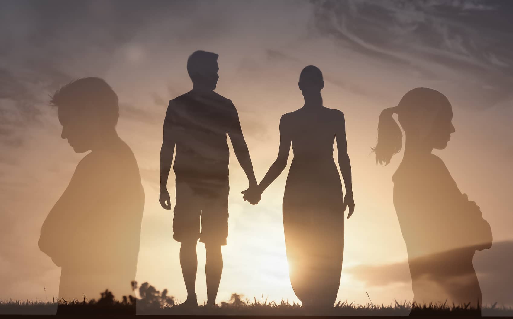 A man and woman walking into the sun holding hands: to be close or in conflict??