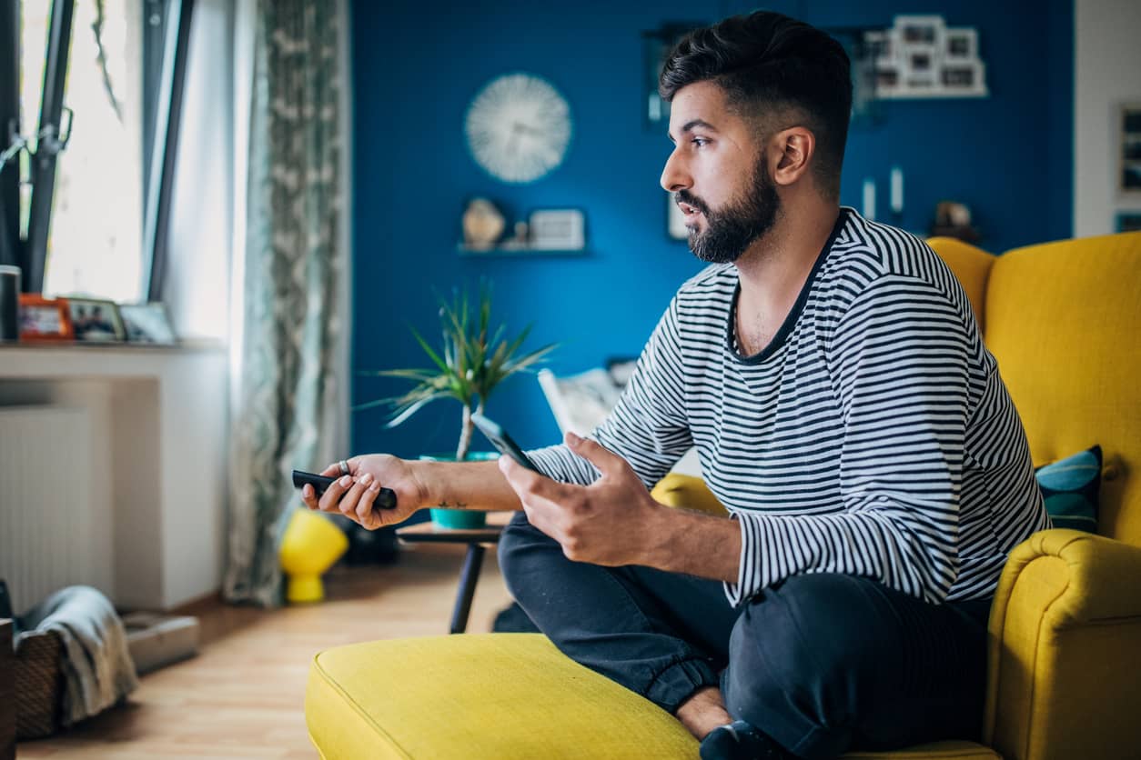 A man decompressing in front of the television