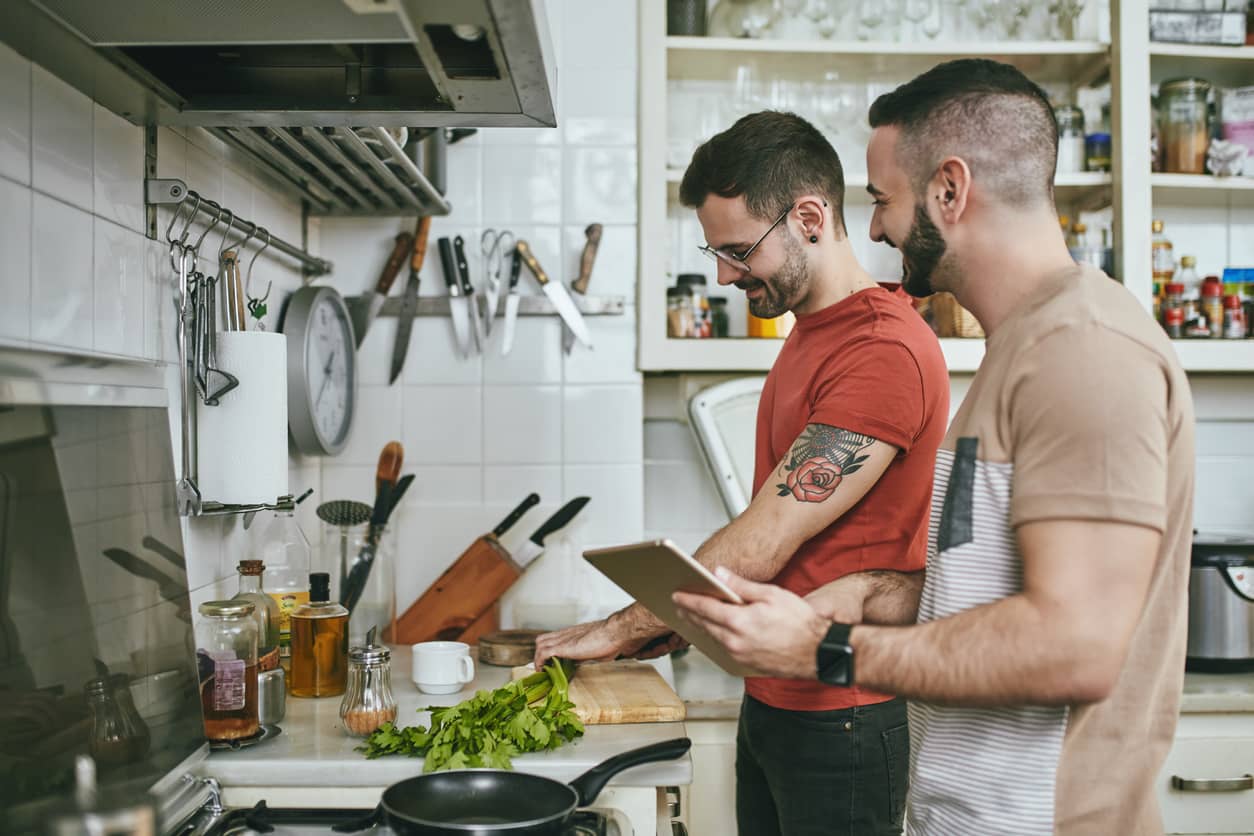 Man-standing-by-boyfriend-preparing-food-at-home-1137542364_Compressed