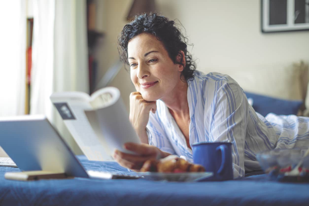 Lovely woman reading and giving herself self-compassion