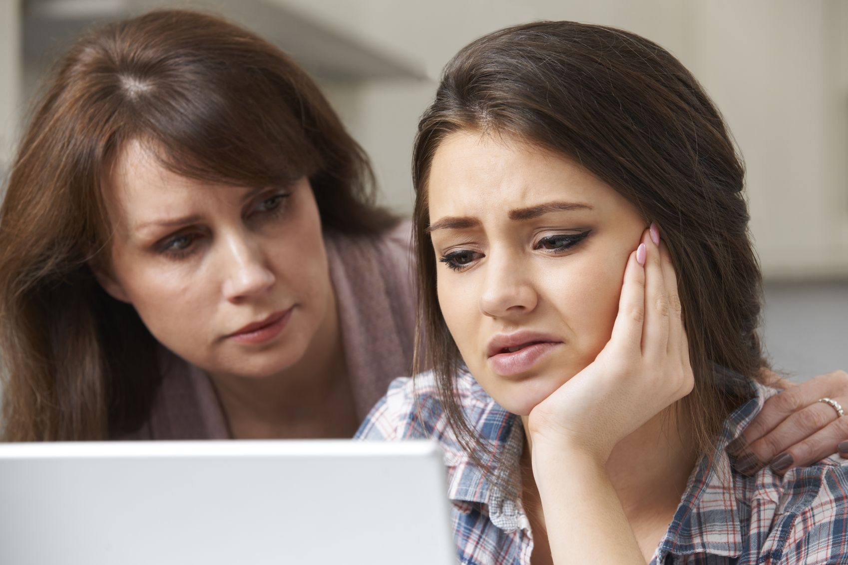 Mom empathizes and comforts her stressed teenage daughter