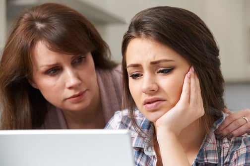 A mom encouraging her frustrated teenager with her homework