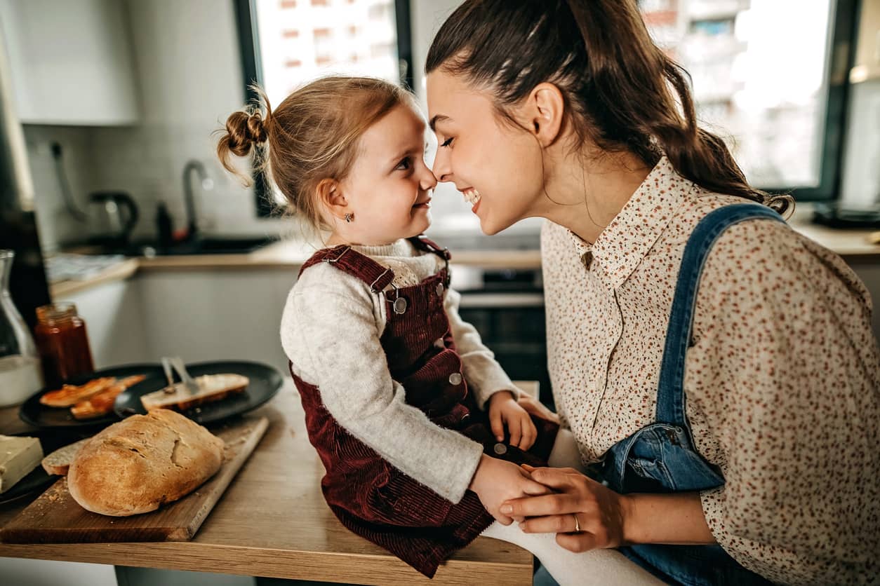 Mother creating a playful and meaningful moment with her 3-year-old daughter by rubbing noses