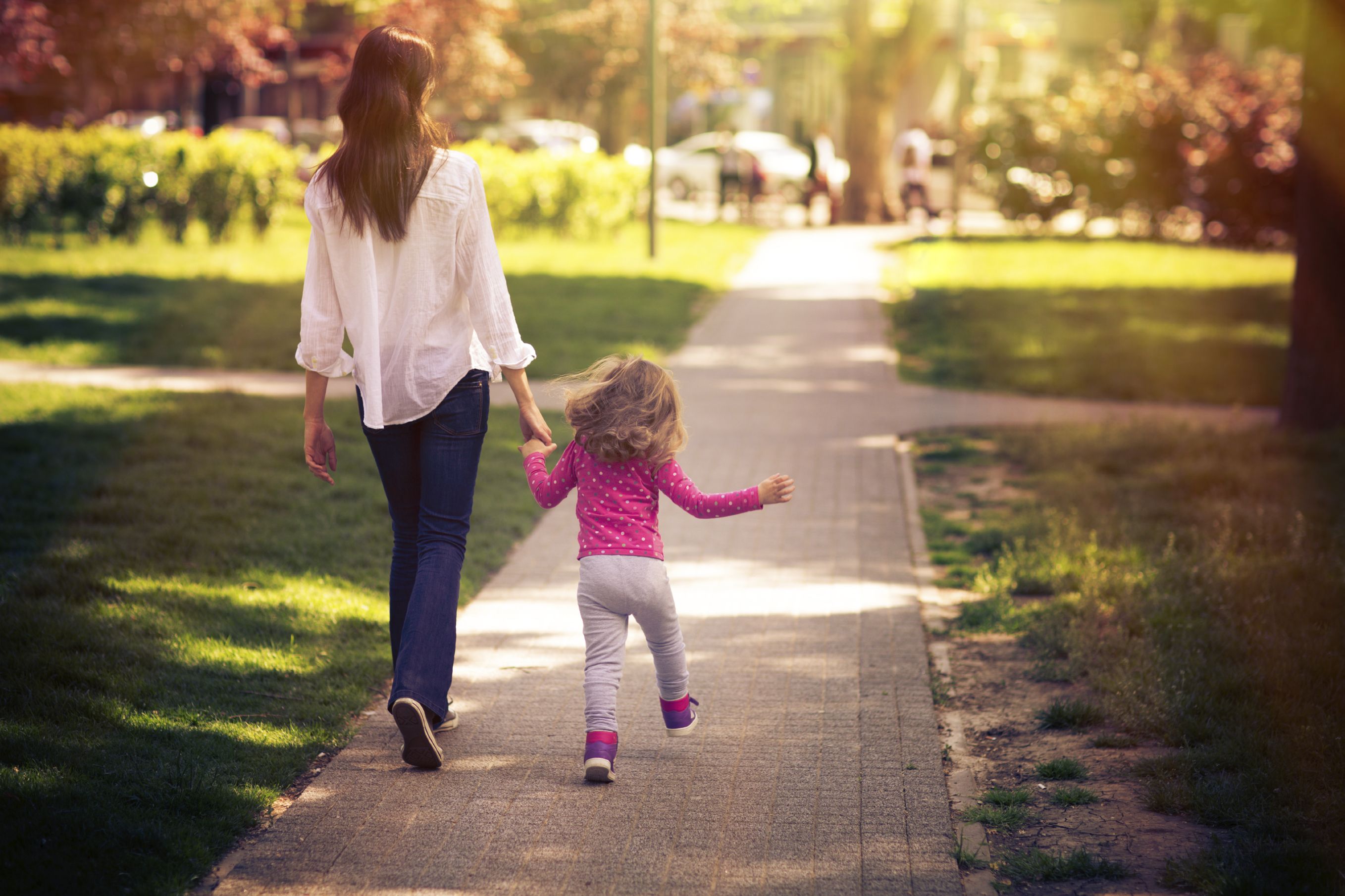 Mother and daughter walking in the park