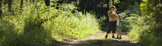 Mother and daughter walking in the woods