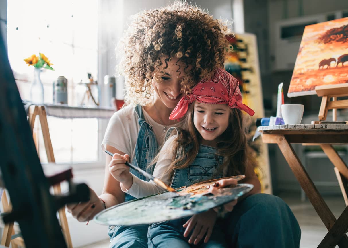 Mother and daughter exploring colors and painting