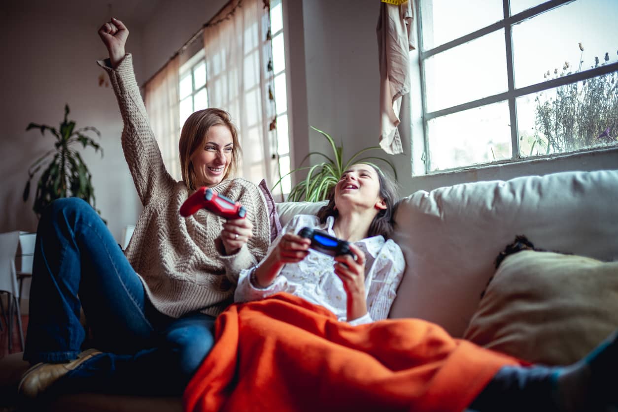 Mother and daughter playing video games