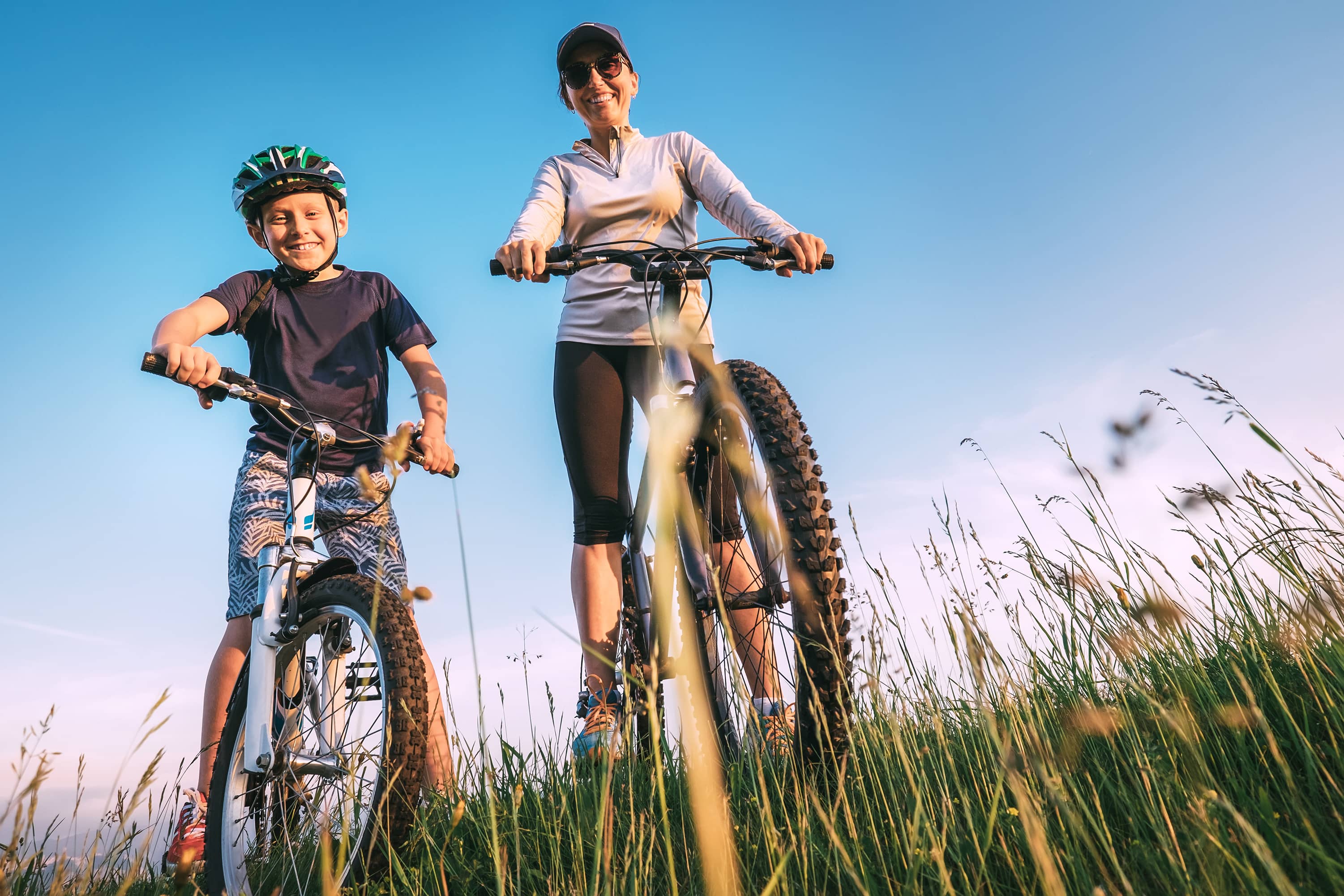 Mother and son riding bikes together.