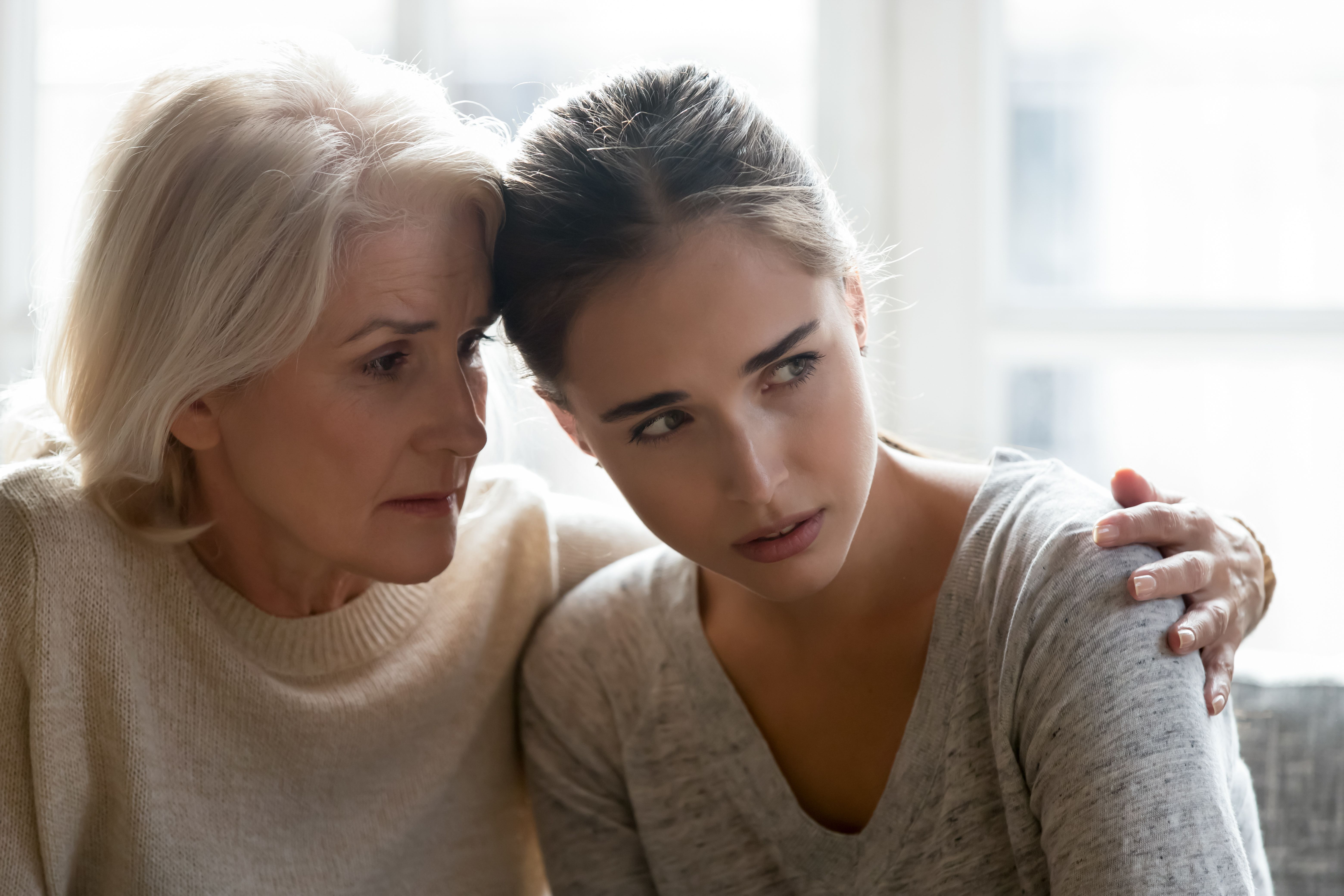 Mother comforting and empathizing with her daughter.