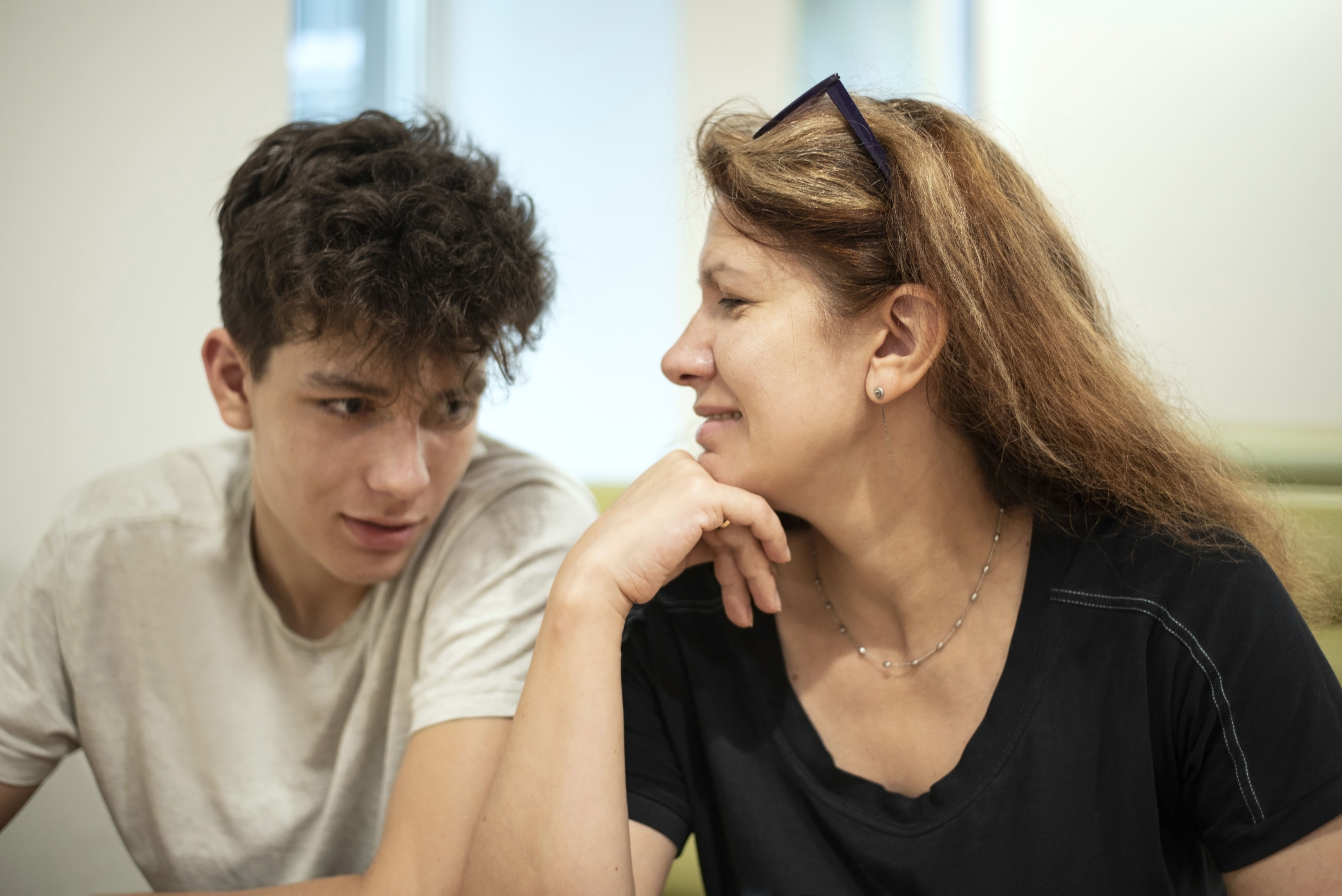 Mother looking lovingly at her teenager