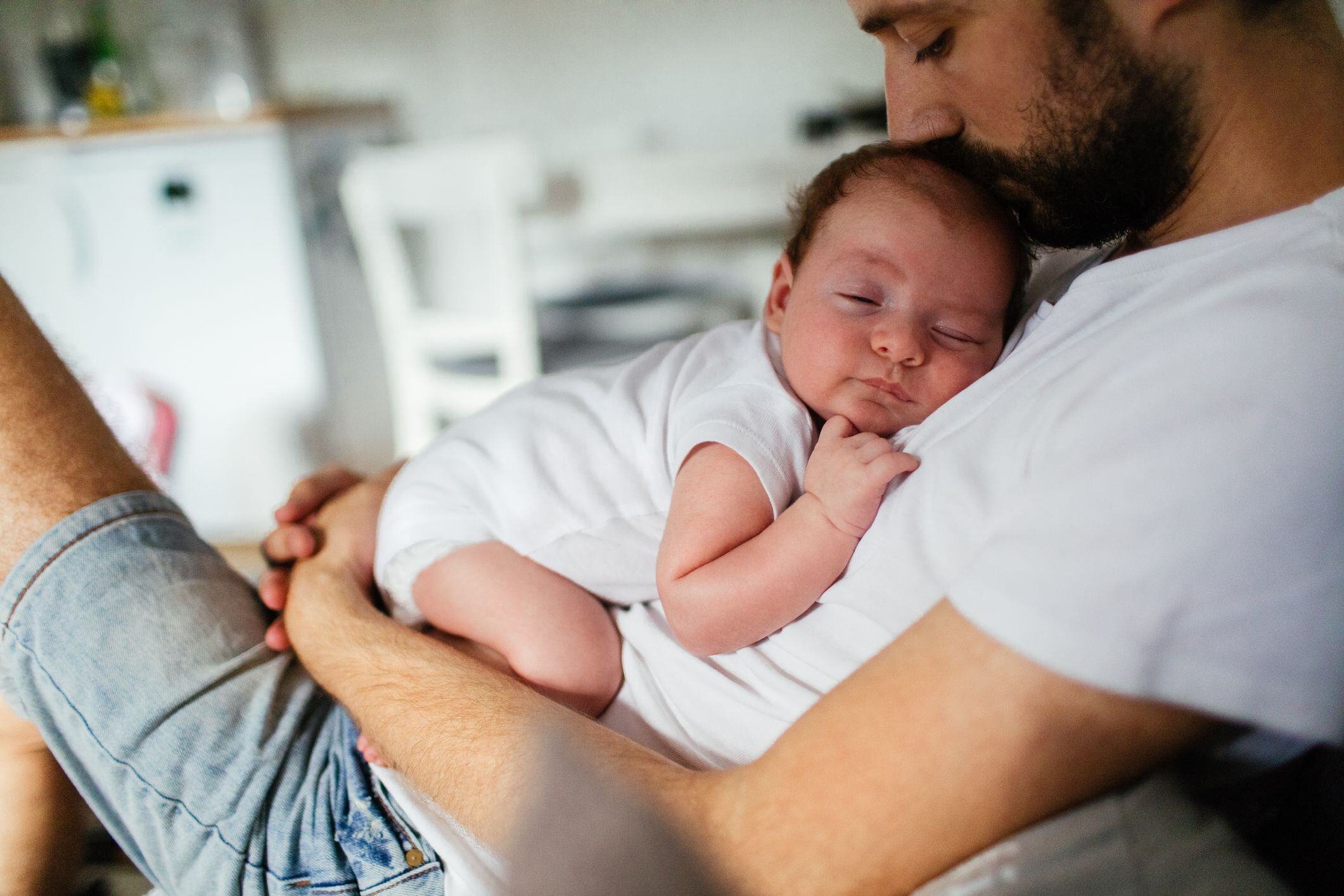 Napping time, a young infant asleep on her fathers chest.