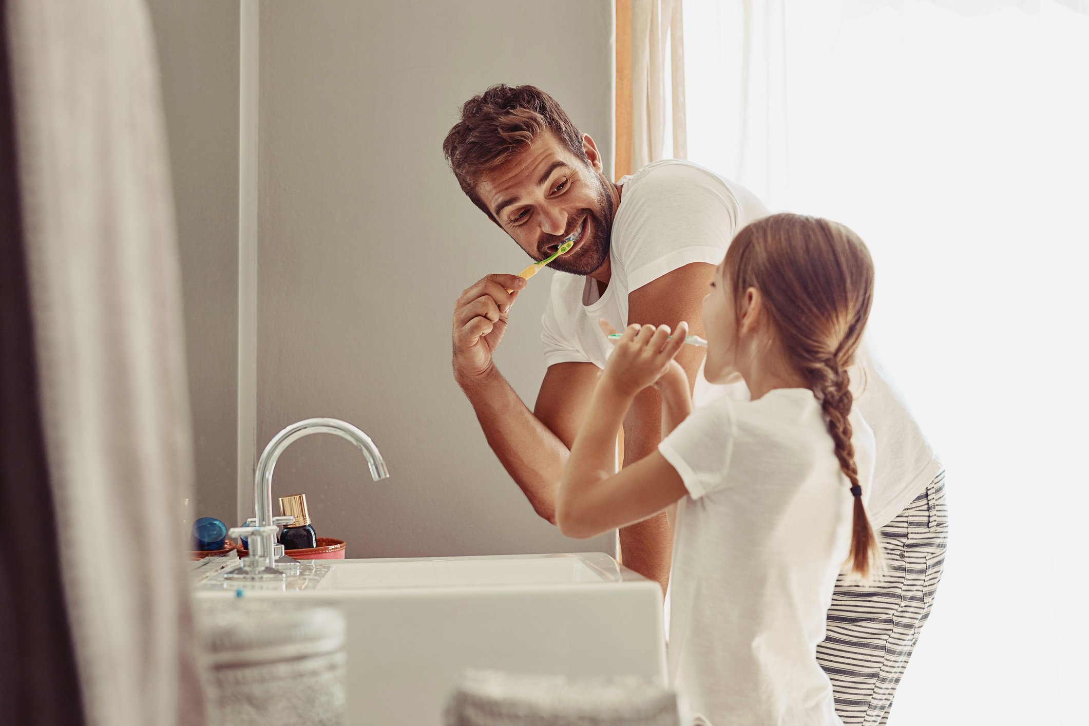 A father and daughter brushing their teeth and making memories