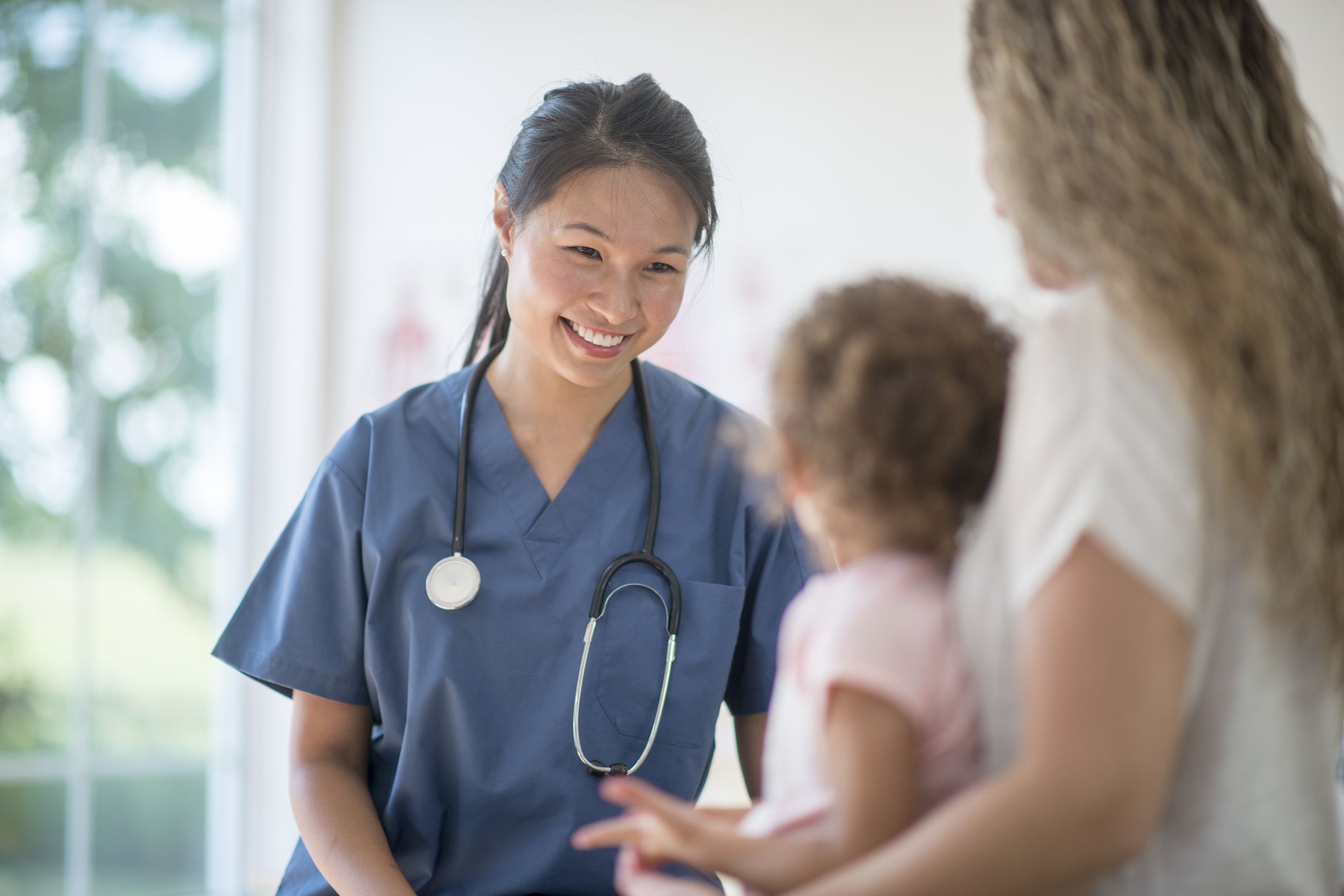 A pediatric nurse caring for a little girl