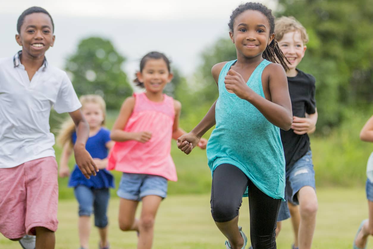 Children running to greet newcomers