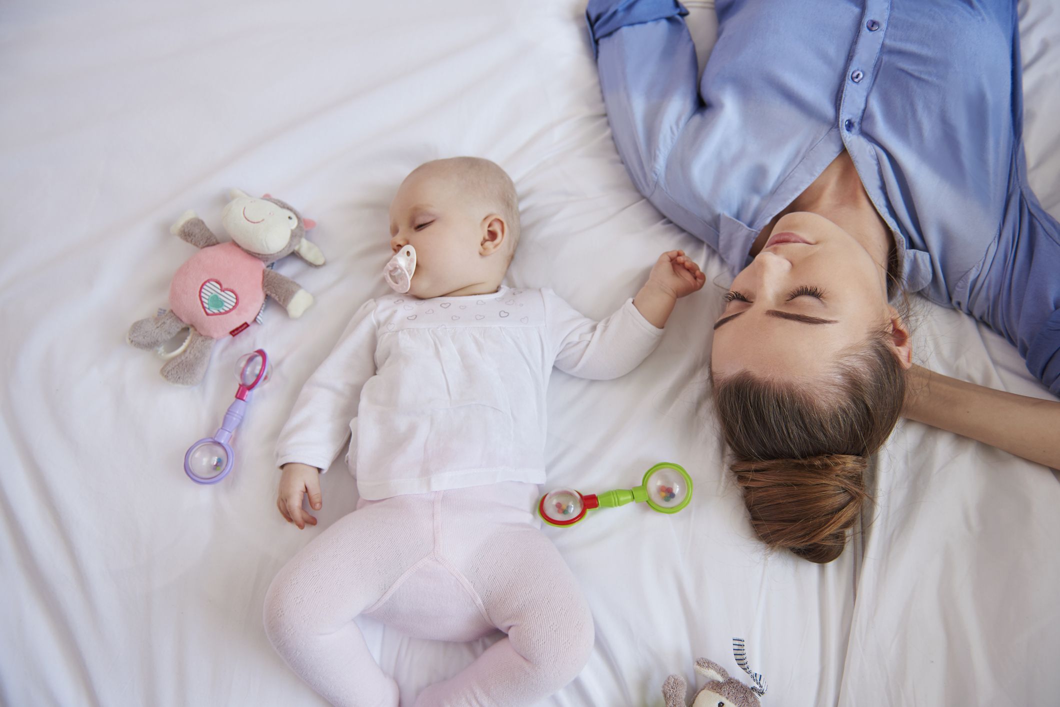 Exhausted mother worn out from a fussy baby who finally sleeps.