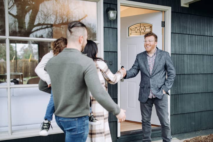 Real Estate agent meeting a prospective buyer at a house