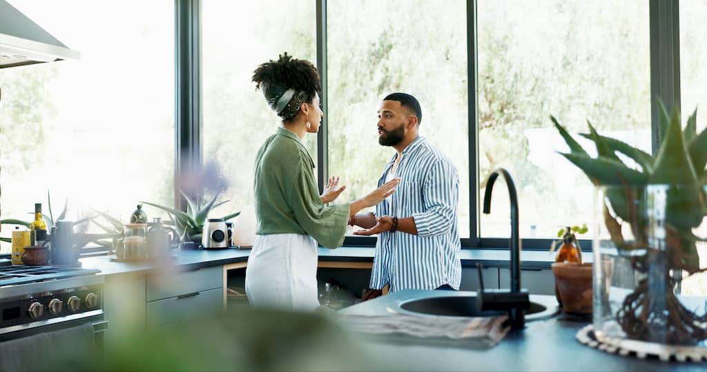 Resentment in a relationship blows and a couple argues in the kitchen.