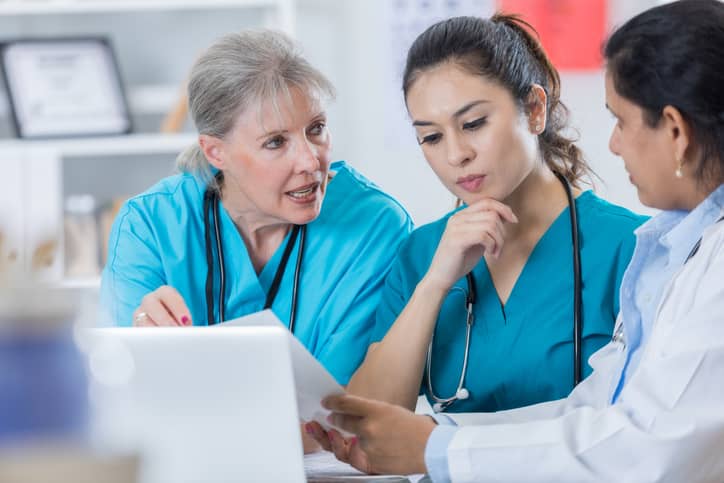 Head nurse discussing patient care at the end of a shift.