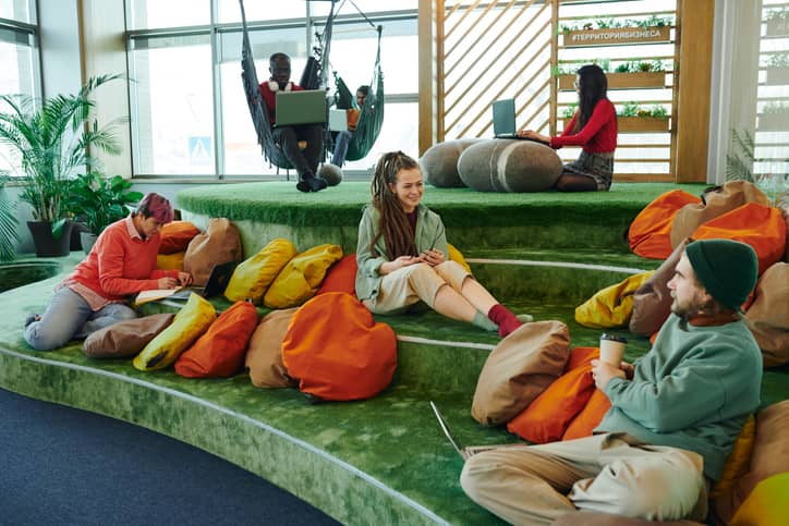 Several young managers meeting in a large contemporary open space.