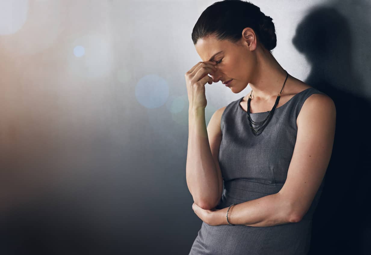 A young woman struggling with a headache