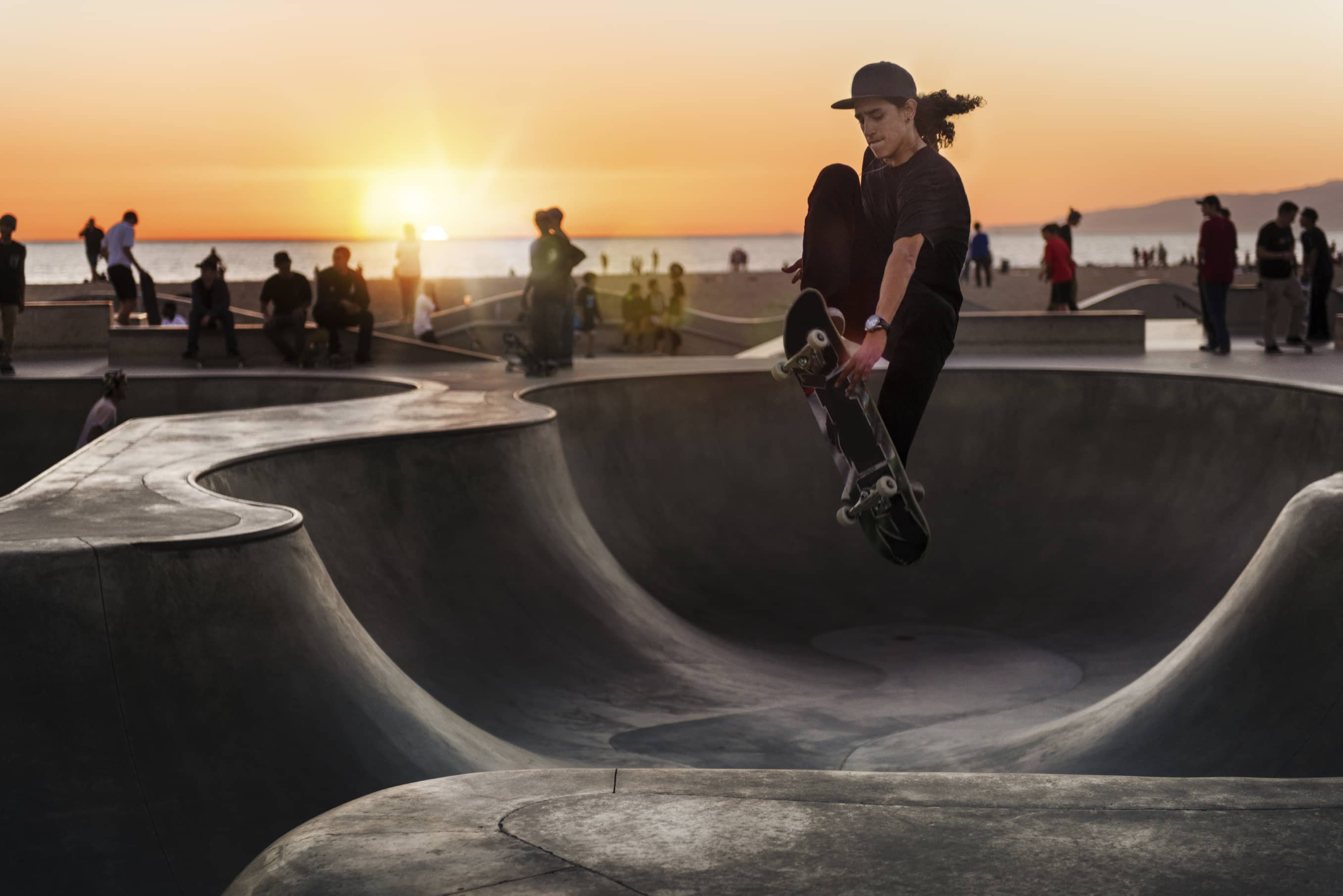 Man skateboarding at sunset motivated by intrinsic motivation and passion.