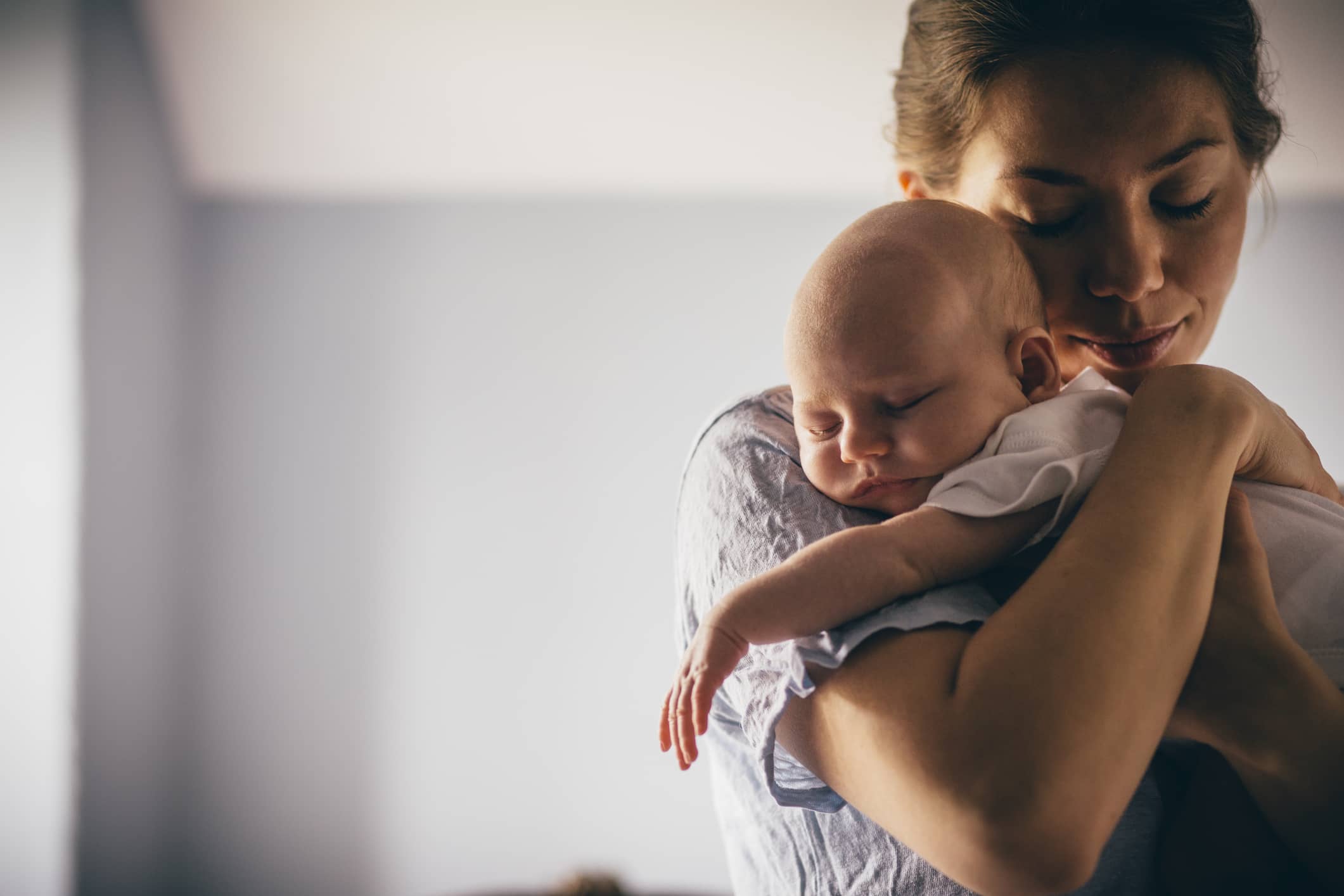 Tired mom with holding her infant