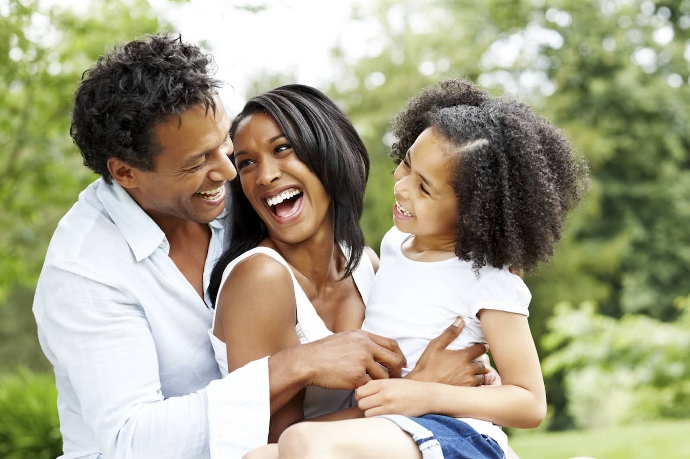 Smiling young black family on holiday.