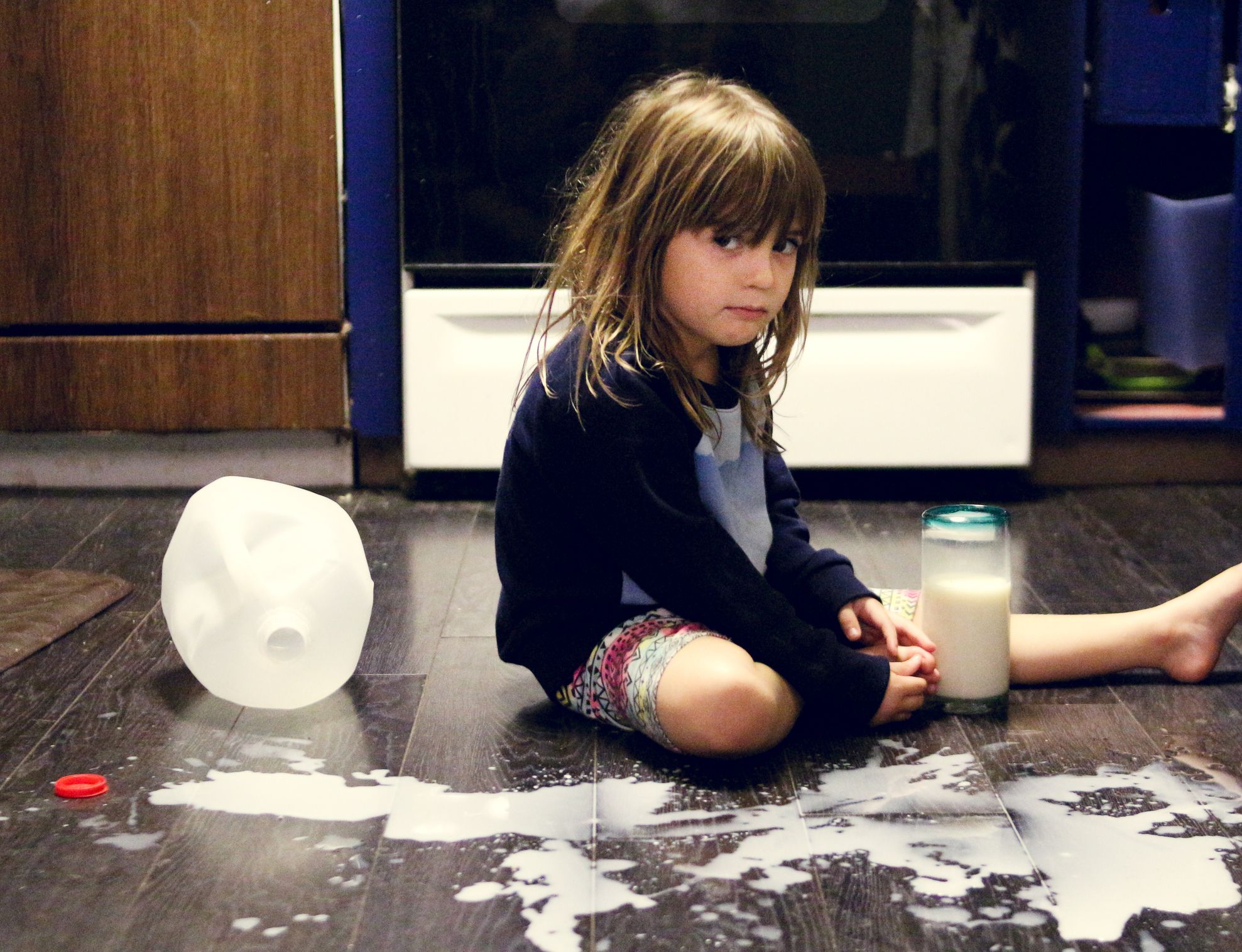 A preschooler sitting on the kitchen floor with a gallon of spilt milk: a mess or a teaching moment?