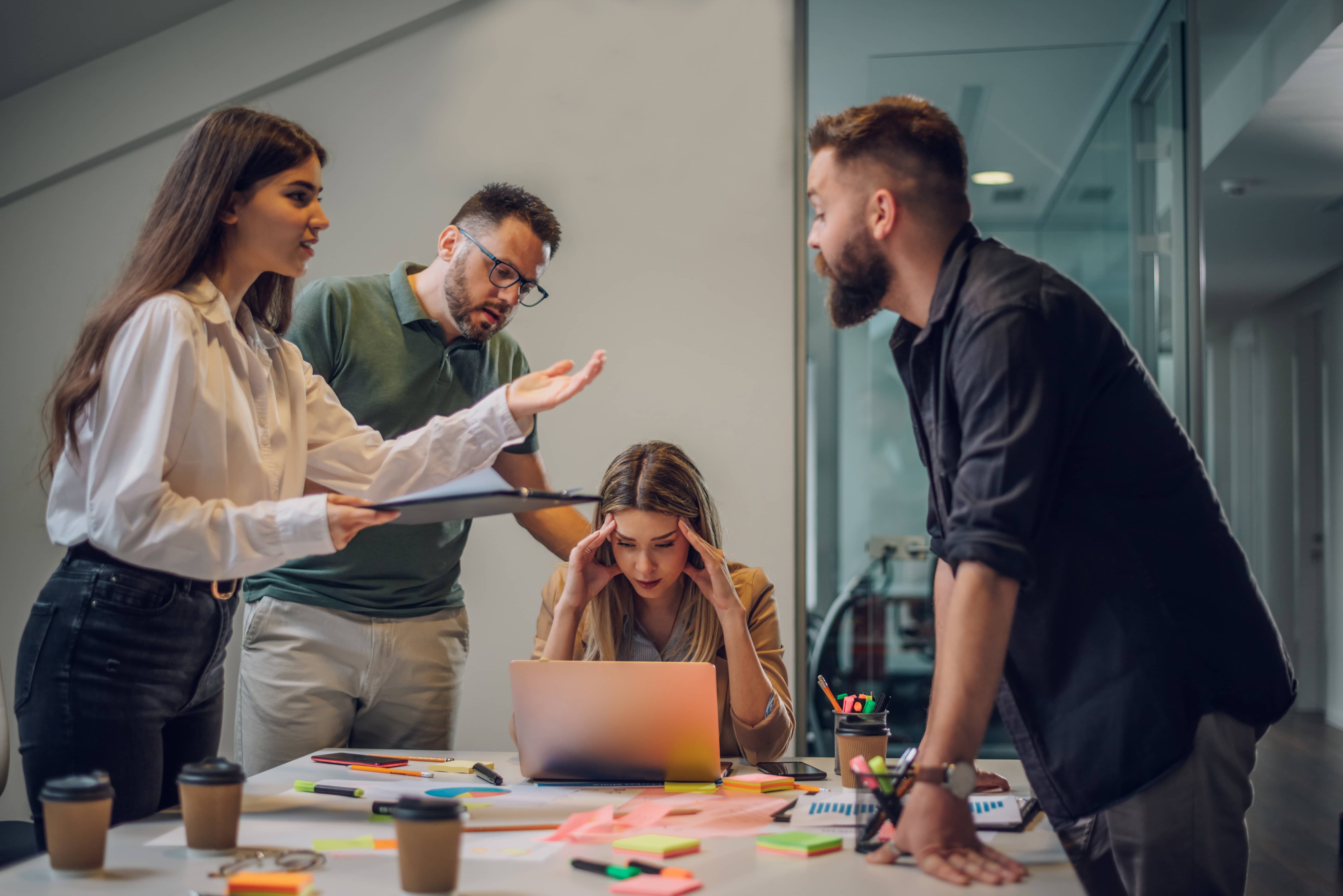 Stressed business colleagues arguing and in workplace drama.