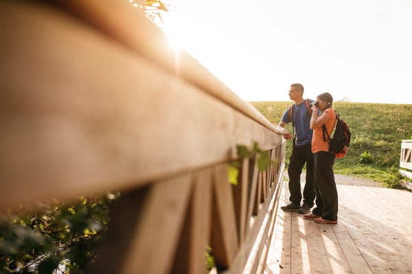 Married couple shooting photos at a bridge